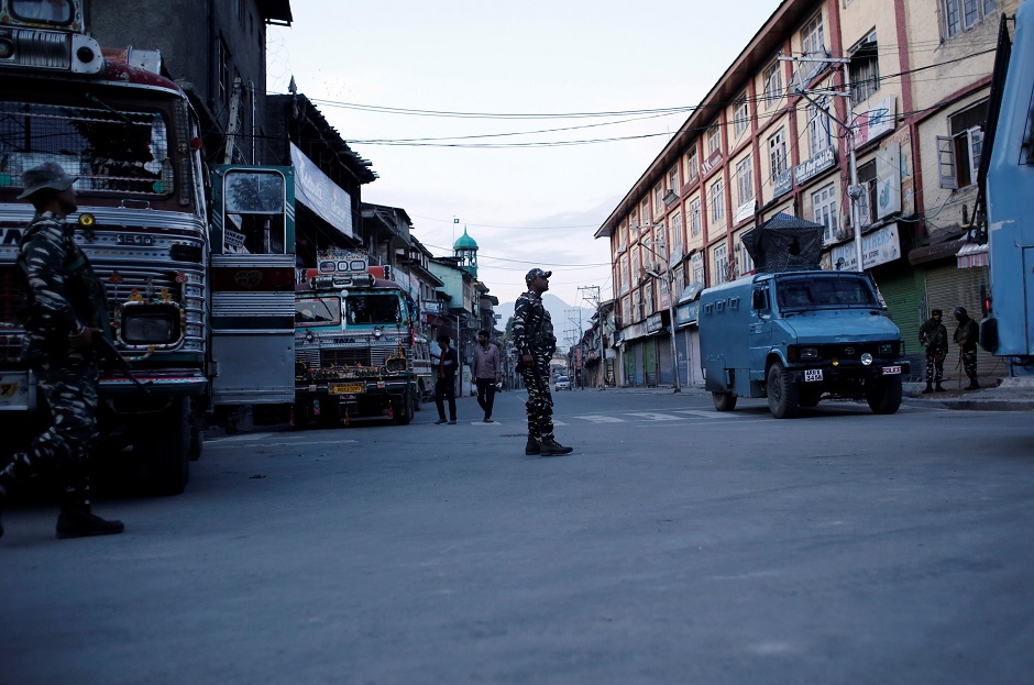 Indian security force personnel stand guard on a deserted road during restrictions after scrapping of the special constitutional status for Kashmir by the Indian government, in Srinagar. PHOTO: REUTERS 
