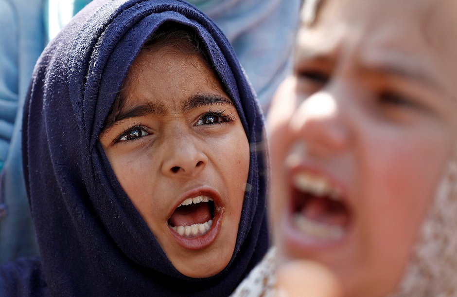 Kashmiri girls shout slogans as they attend a protest after Friday prayers during restrictions, after scrapping of the special constitutional status for Kashmir by the Indian government. PHOTO: REUTERS 