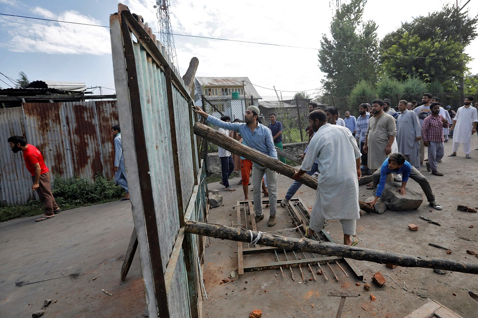 Kashmiris reinforce a barrier during clashes with Indian security forces, after scrapping of the special constitutional status for Kashmir by the Indian government, in Srinagar. PHOTO: REUTERS 