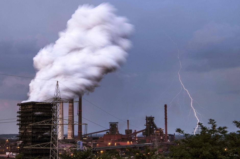 Lightnig hits the ground behind the cokery plant and blast furnace of German industrial congl, omerate ThyssenKrupp in Duisburg. PHOTO: AFP