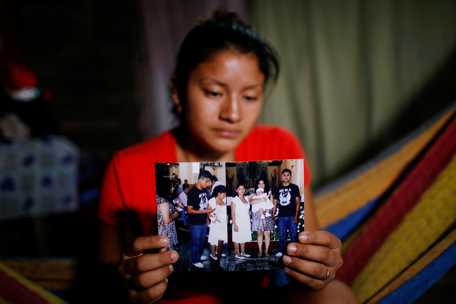 Norme Mendez, wife of Salvadoran migrant Marvin Antonio Gonzalez, who recently died in a border detention center in New Mexico, shows pictures of Marvin at her home in Verapaz, El Salvador. PHOTO: Reuters