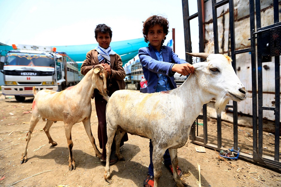 Yemeni children pose with goats at a livestock market in the capital Sanaa as people buy provisions in preparation for the Eidul Azha celebrations. PHOTO: AFP