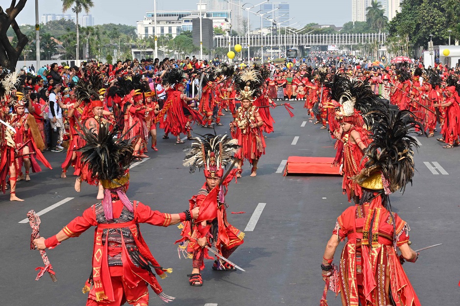 Indonesian dancers perform with masks of Cirebon during a flashmob entitled 