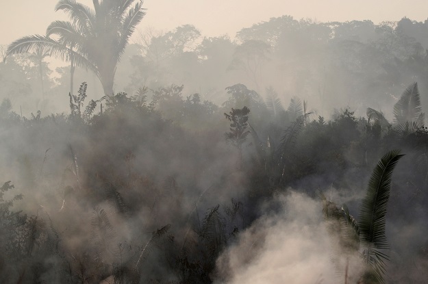 Smoke billows during a fire in an area of the Amazon rainforest. PHOTO: Reuters