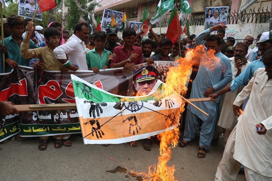 Protesters burn an Indian flag during a protest in Hyderabad on August 15, 2019, as the country observes 'Black Day' on India's Independence Day. PHOTO: AFP