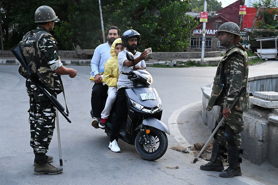 A motorist shows his identity card to a security personnel after being stopped for questioning at a roadblock during a lockdown in Srinagar on August 12, 2019. PHOTO: AFP