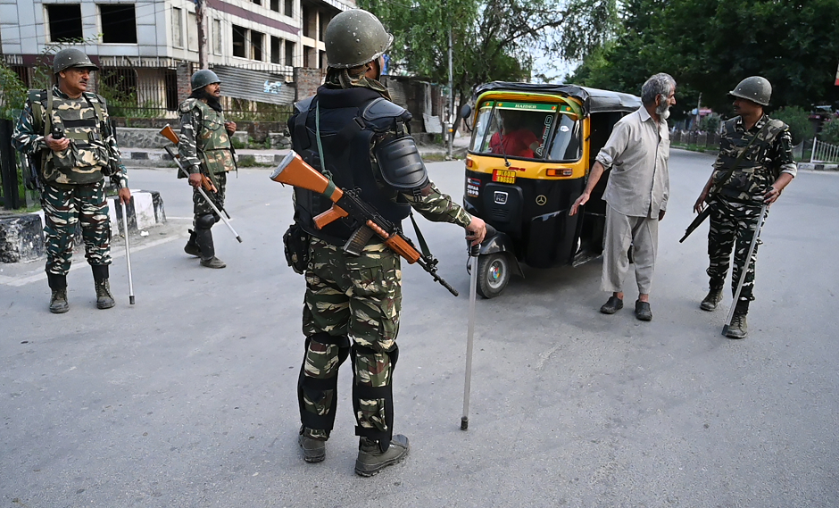 Security personnel stop a man for questioning during a lockdown in Srinagar on August 12, 2019. PHOTO: AFP