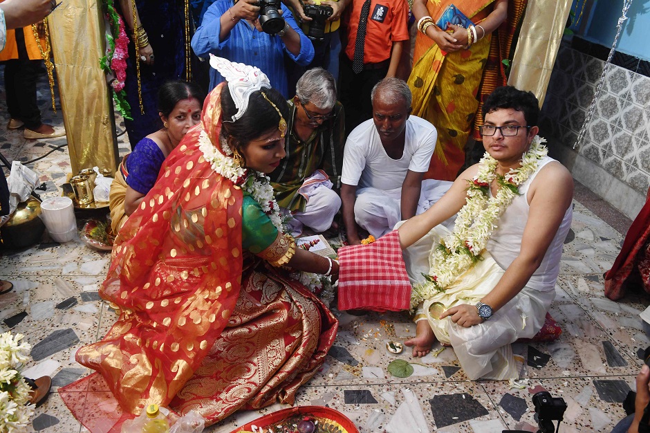 This photo shows transgender woman Tista Das (L) 38, and transgender man Dipan Chakraborty, 40, performing the rituals of a traditional Hindu marriage ceremony in Kolkata. PHOTO: AFP