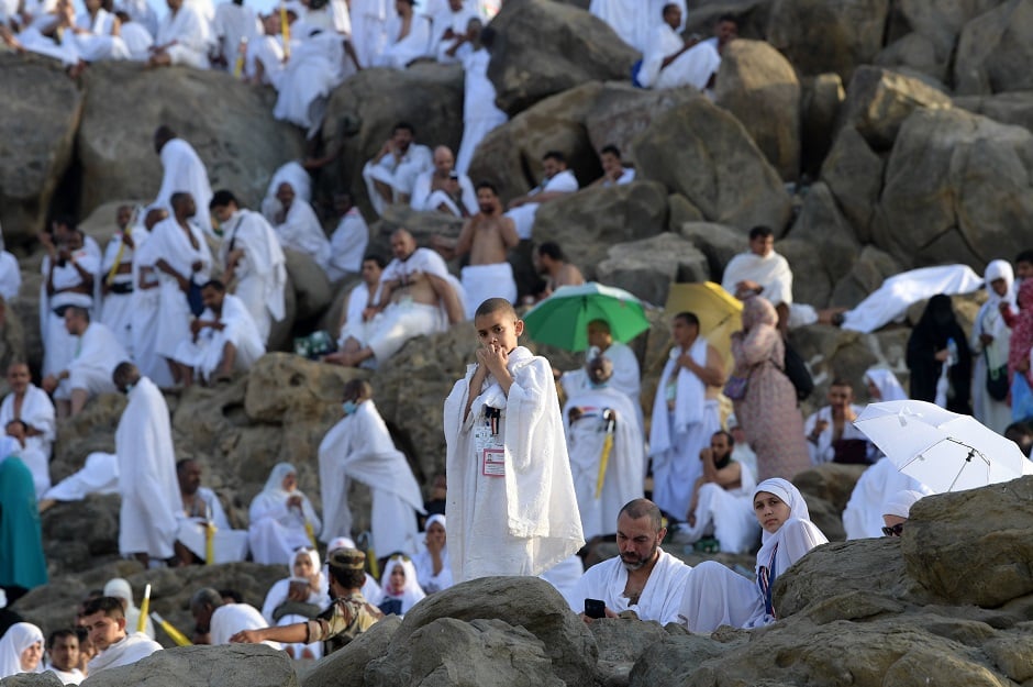 Muslim pilgrims including young children pray at Mount Arafat, also known as Jabal al-Rahma (Mount of Mercy), southeast of the Saudi holy city of Mecca. PHOTO: AFP