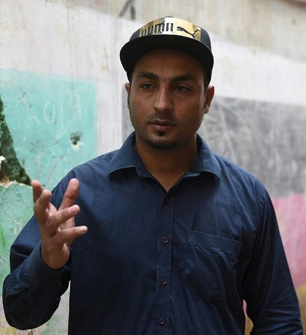 Music producer Qammar Anwar Baloch says the work of Lyari's rappers reflects the hard realities of life in the neighbourhood. PHOTO: AFP.