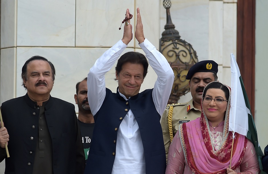 Prime Minister Imran Khan estures as he arrives to address the nation outside the Prime Minister's Office in Islamabad. PHOTO: AFP