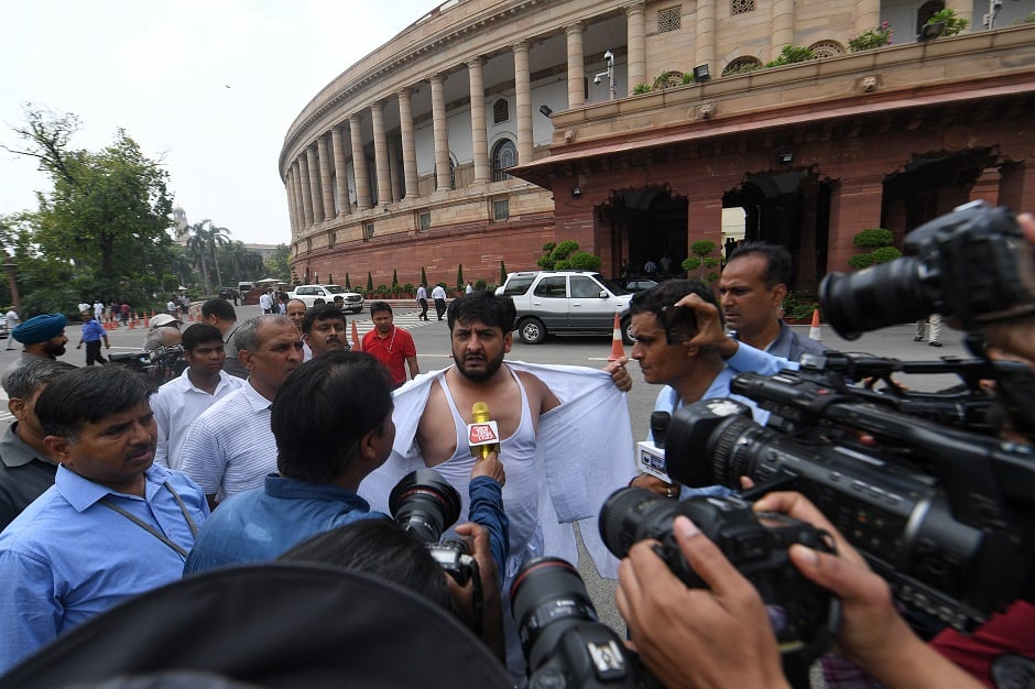 Fayaz Ahmad Mir (C) member of Parliament representing the state of Jammu & Kashmir in Rajya Sabha interact with media at the Parliament house in New Delhi on August 5, 2019. - The Indian government on August 5 rushed through a presidential decree to scrap a special status for disputed Kashmir, hours after imposing a major security clampdown in the region. (Photo by PRAKASH SINGH / AFP)