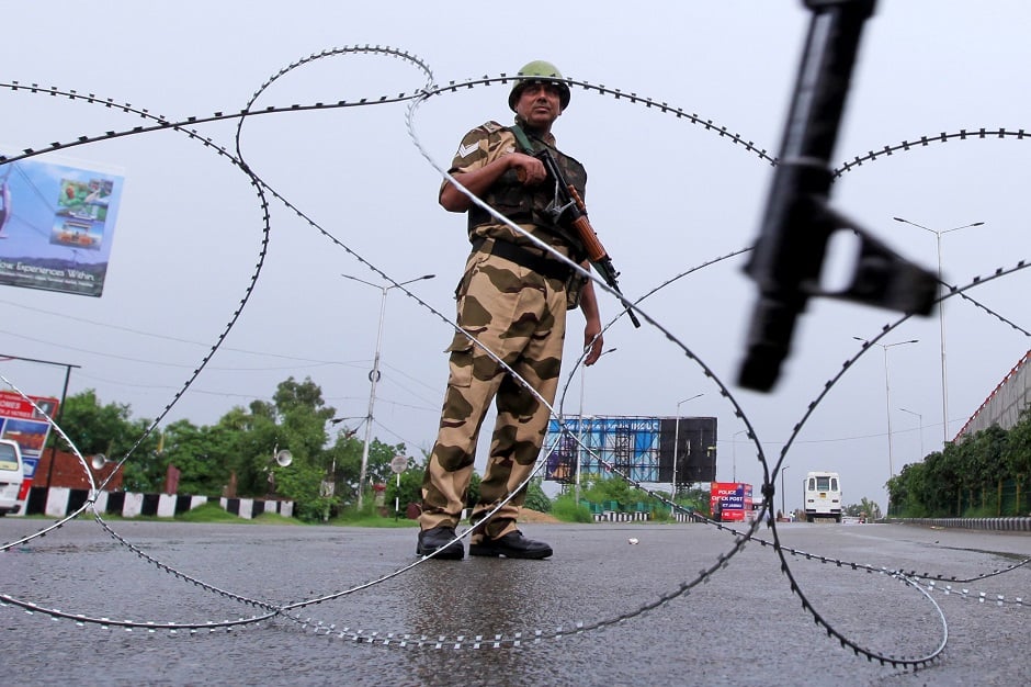 A security personnel stands guard at a roadblock in Jammu. PHOTO: AFP