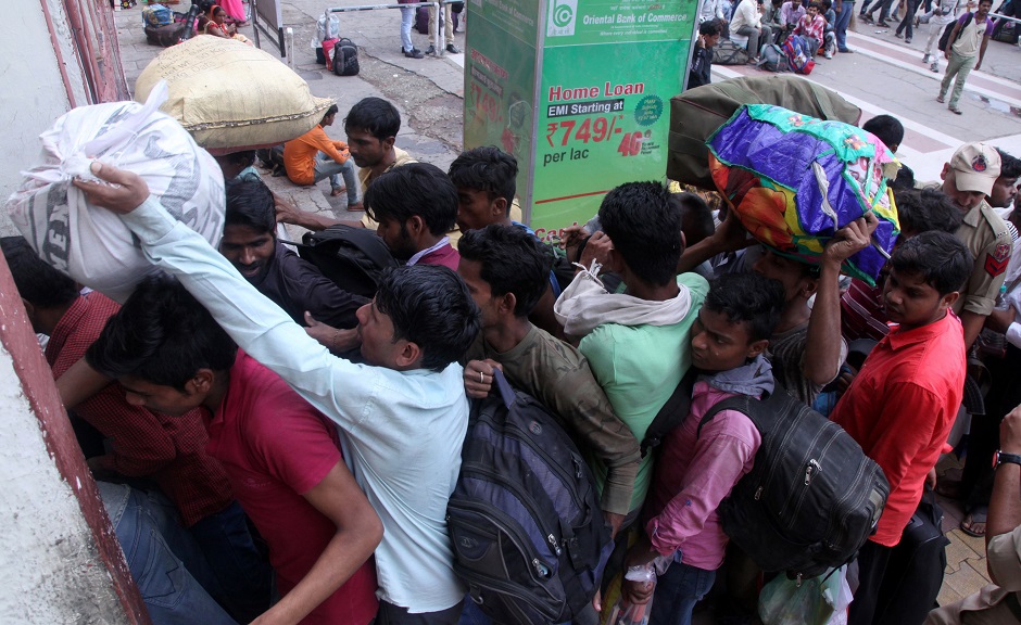 Labourers from across India working in Kashmir wait outside Jammu Railway Station as they leave to go back to their home states due to the heightened security situation in Jammu. PHOTO: AFP