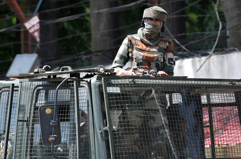 In this file photo taken on August 18, 2019, an occupying soldier stands alert in a truck while travelling in a convoy in Srinagar. PHOTO: AFP