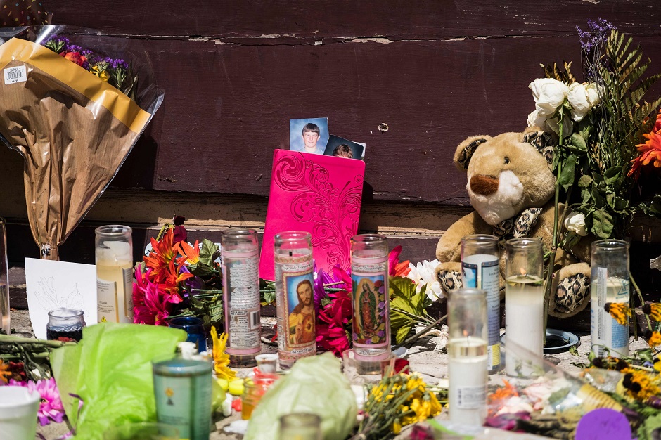 Candles and Flowers are placed at Ned Peppers after the mass shooting over the weekend in Dayton, Ohio. PHOTO: AFP