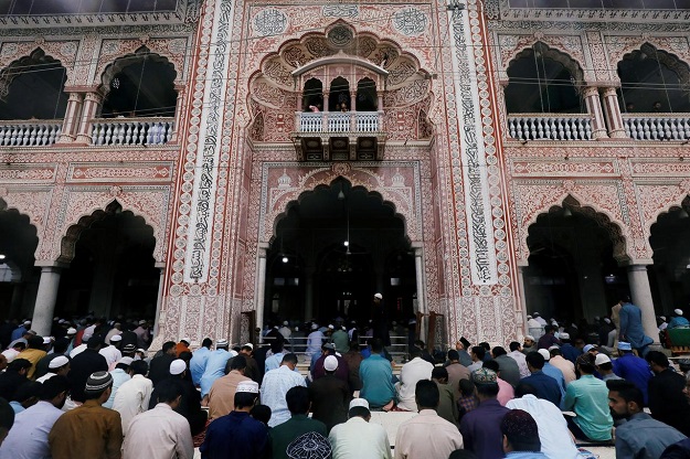 Men attend Eid al-Adha prayers at a mosque in Karachi. PHOTO: REUTERS