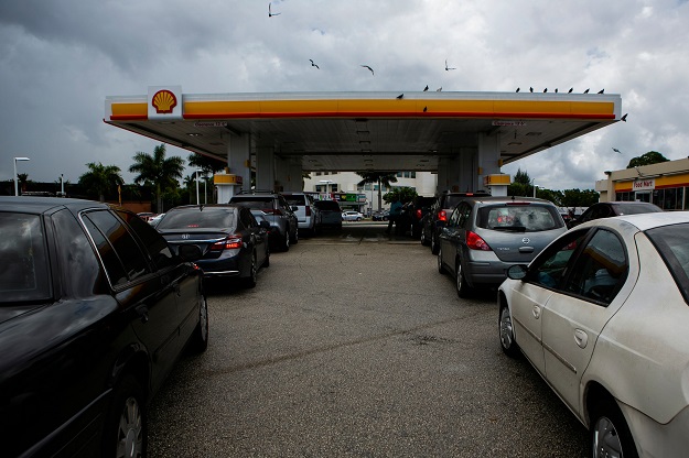 People line up to fill up their car with gas at a Shell station in Miami. PHOTO: AFP