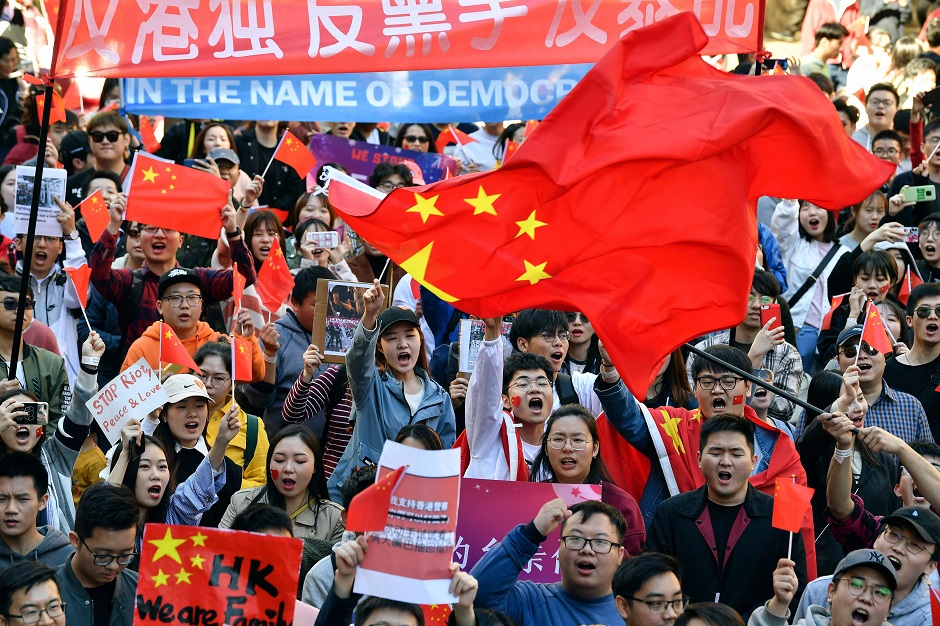 Pro-China activists march on the streets of Sydney, as they rally against ongoing protests in Hong Kong. PHOTO: AFP
