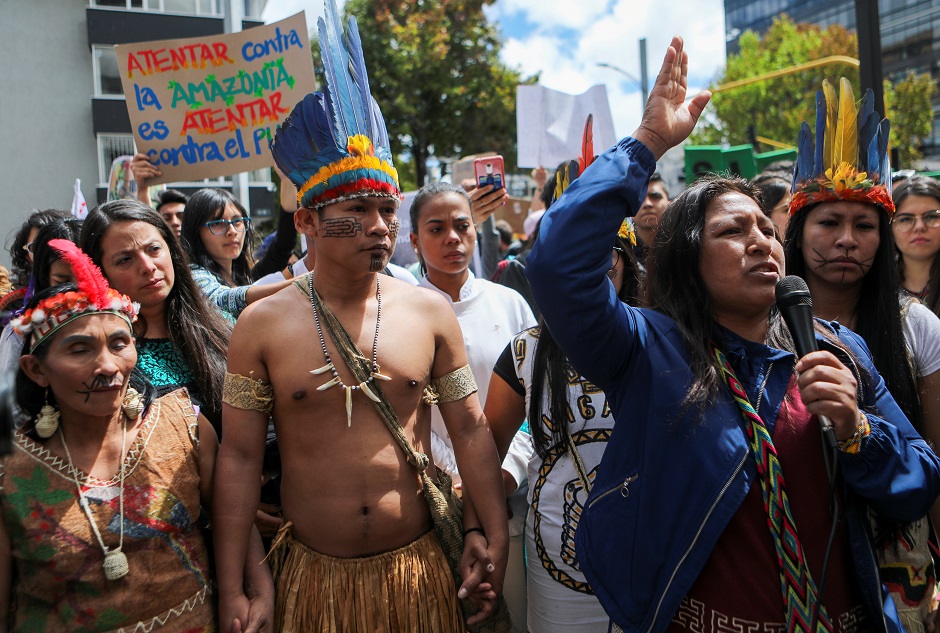 A group of indigenous people attend a protest outside the Brazilian embassy due to the wildfires in the Amazon rainforest, in Bogota. PHOTO: Reuters