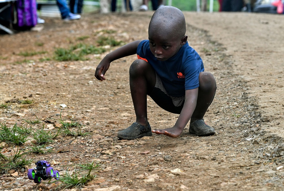 A migrant boy plays at the Temporary Station of Humanitarian Assistance (ETAH) in the village of La Penita, Darien Province, Panama. PHOTO: AFP