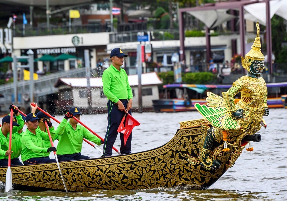 Royal Thai Navy personnel row during a rehearsal for the Royal Barge Procession along the Chao Phraya river in Bangkok on August. PHOTO: AFP