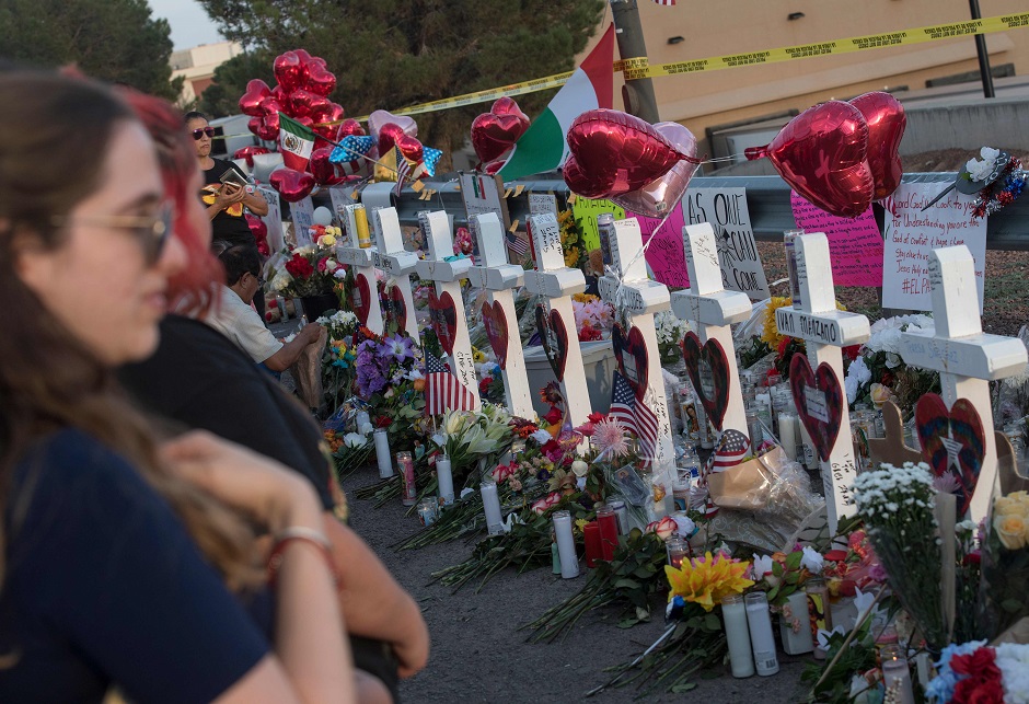 People pay their respects at a makeshift memorial for victims of Walmart shooting that left a total of 22 people dead at the Cielo Vista Mall WalMart in El Paso, Texas. PHOTO: AFP