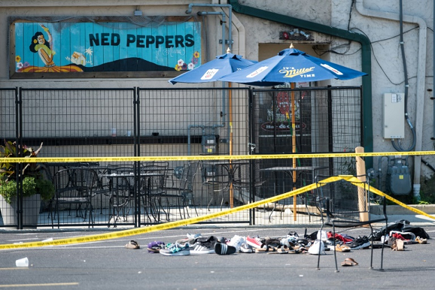 Shoes belonging to victims of the shooting outside Ned Peppers bar, in Dayton, Ohio, are piled after a gunman armed with an assault rifle killed nine people. PHOTO: AFP