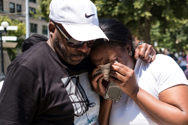 A couple mourn at a vigil for victims of the shooting in Dayton, Ohio, which killed nine people 13 hours after another gunman in El Paso, Texas, murdered 29 people. PHOTO: AFP