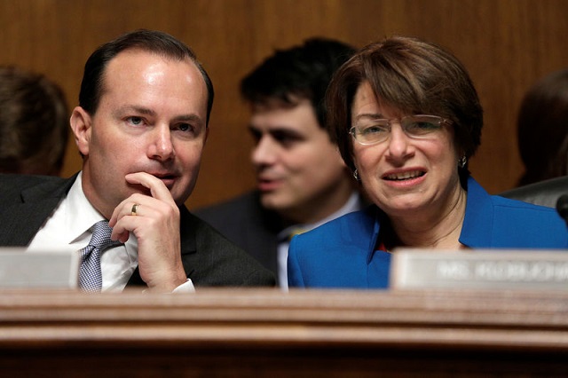 chairman-of-the-senate-judiciary-committee-antitrust-subcommittee-mike-lee-speaks-with-amy-klobuchar-before-a-hearing-on-the-proposed-deal-between-att-and-time-warner-in-washington