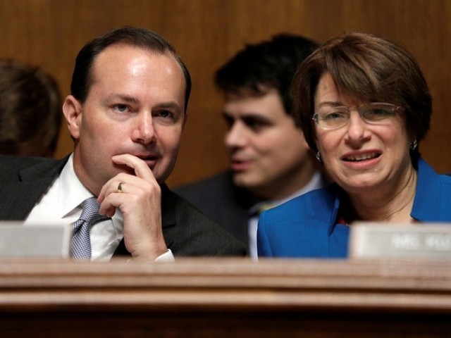 FILE PHOTO: Chairman of the Senate Judiciary Committee Antitrust Subcommittee Mike Lee (R-UT) speaks with Amy Klobuchar (D-MN) before a hearing in Washington, US, December 7, 2016. PHOTO: REUTERS