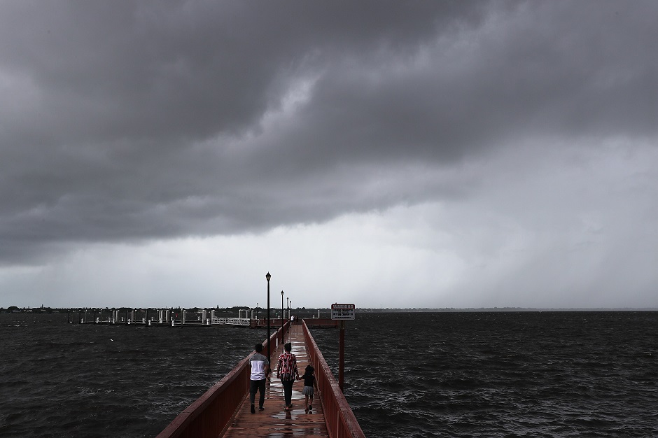  People walk along the Boardwalk Run as Hurricane Dorian continues to make its way toward the Florida coast . PHOTO: AFP