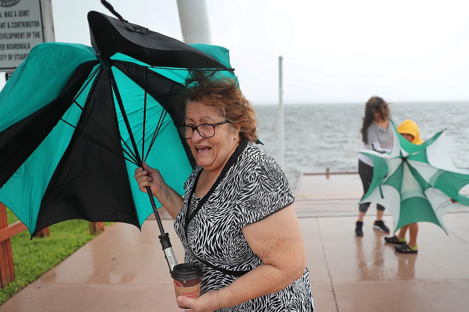 Sonya Temeloski holds her umbrella as a band of rain and wind pass over the area as Hurricane Dorian continues to make its way toward the Florida coast. PHOTO: AFP