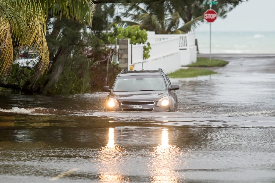 A car drives through a flooded street after the effects of Hurricane Dorian arrived in Nassau, Bahamas. PHOTO: REUTERS 