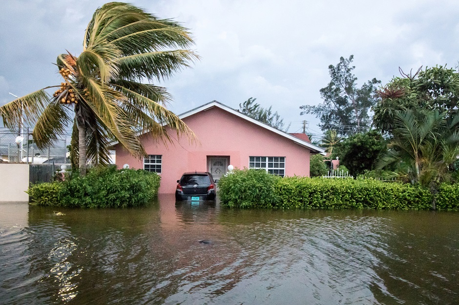 A palm tree bends in the wind next to a flooded street after the effects of Hurricane Dorian arrived in Nassau, Bahamas. PHOTO: REUTERS 