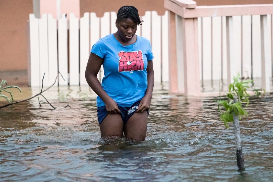  A woman walks in a flooded street after the effects of Hurricane Dorian arrived in Nassau, Bahamas. PHOTO: REUTERS