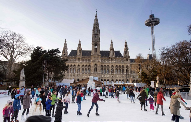 photo taken on February 03, 2015 people ice-skate in front of the Vienna City Hall, designed in 1883 by Austrian architect Friedrich von Schmidt (1825-1891) in Vienna, Austria. PHOTO: AFP