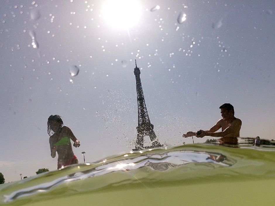 In this photo taken on July 25, 2019 people cool off at the Trocadero Fountains next to the Eiffel Tower in Paris, as a heatwave hits Europe. PHOTO: AFP