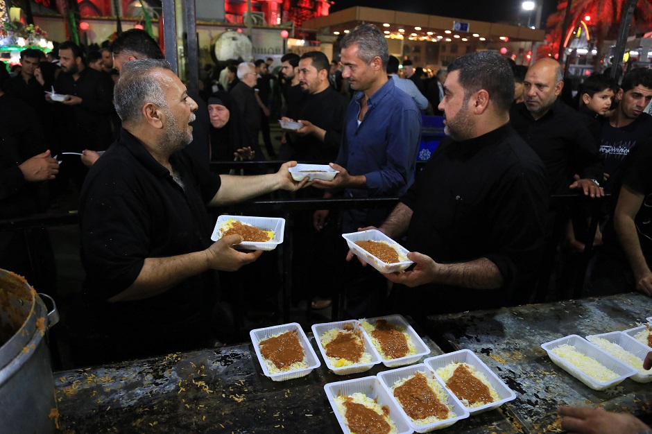 Iraqi Shiites distribute sweets to mourners in the central city of Karbala. PHOTO: AFP