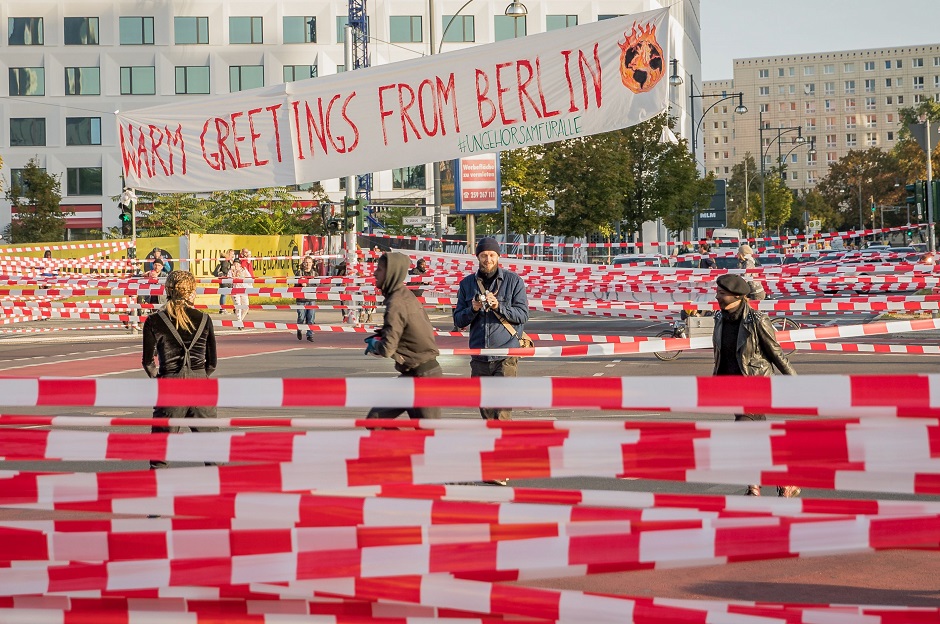 Climate activists block Jannowitz Bridge in Berlin for road traffic with hundreds of plastic cordons and a banner reading 