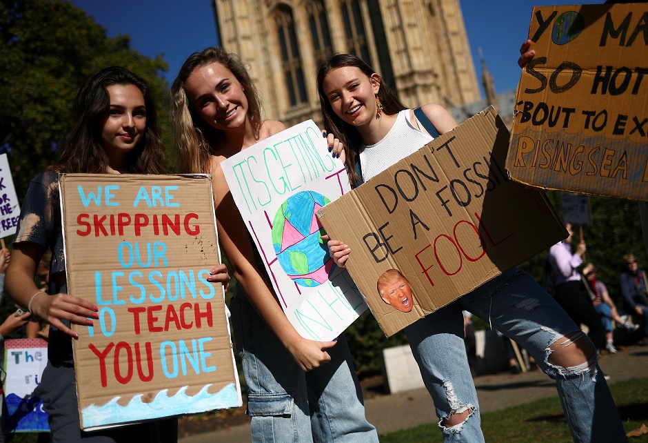  Students hold placards as they attend a climate change demonstration in London, Britain. PHOTO: Reuters 