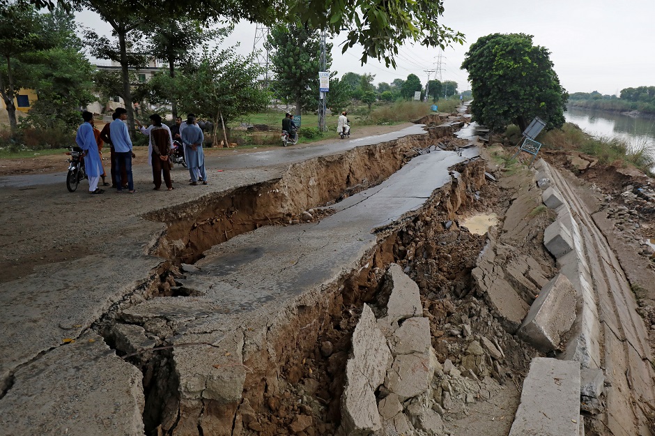  People gather near a damaged road after an earthquake in Mirpur, Pakistan. PHOTO: Reuters 