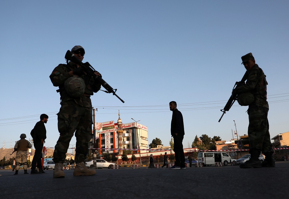 Afghan policemen keeps watch at a checkpoint in Kabul, Afghanistan. PHOTO: Reuters 