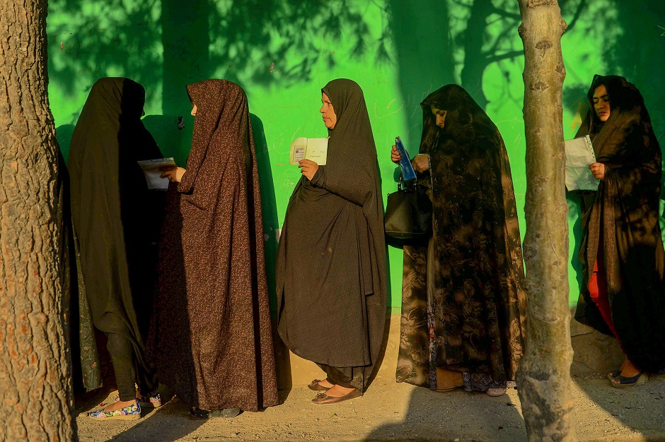 Women queue to cast their vote at a polling station in Herat. PHOTO: AFP