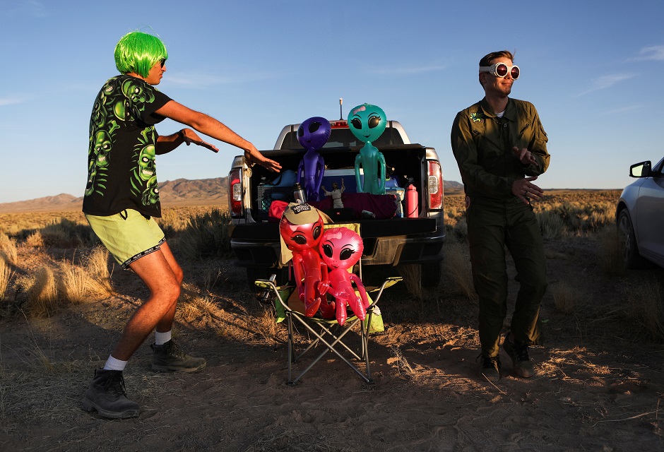 Two men dance on a road to an entrance to Area 51. PHOTO: Reuters
