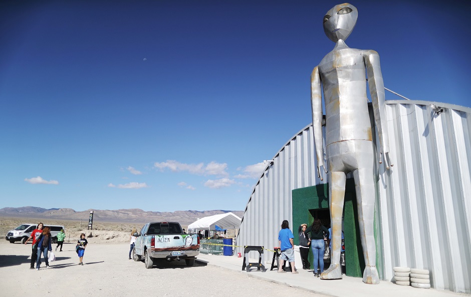 People walk before the start of a 'Storm Area 51' spinoff event called 'Area 51 Basecamp' at the Alien Research Center. PHOTO: AFP