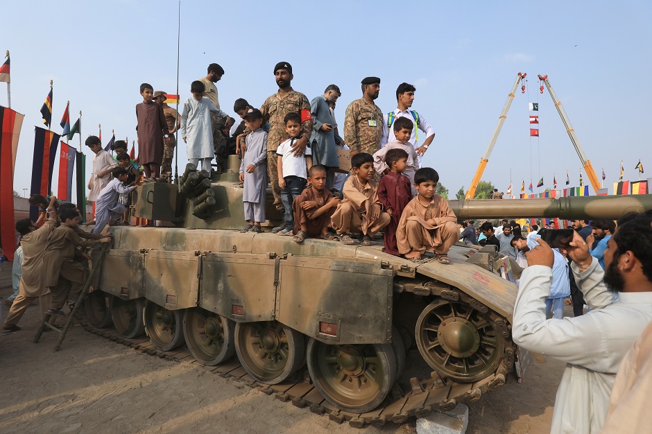 Men and children on a tank pose for pictures during Defence Day ceremonies, or Pakistan's Memorial Day, to express solidarity with the people of Kashmir, in Peshawar, Pakistan September 6, 2019. PHOTO: REUTERS