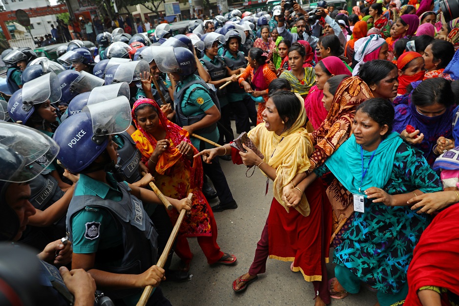  Garment workers react during clashes with police at a protest demanding for arrears in Dhaka, Bangladesh. PHOTO: Reuters