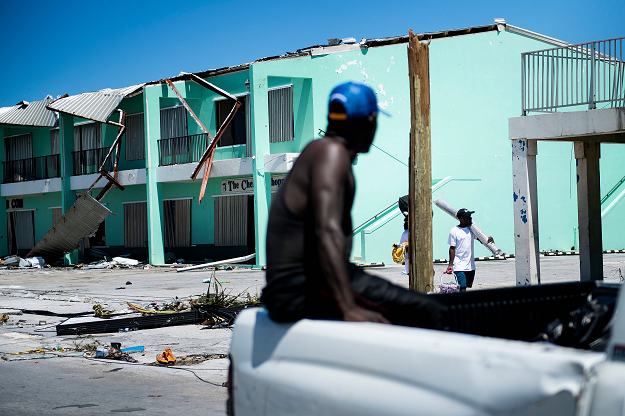People try to salvage construction material in houses damaged by Hurricane Dorian on September 5, 2019, in Marsh Harbour, Great Abaco Island in the Bahamas. PHOTO: AFP