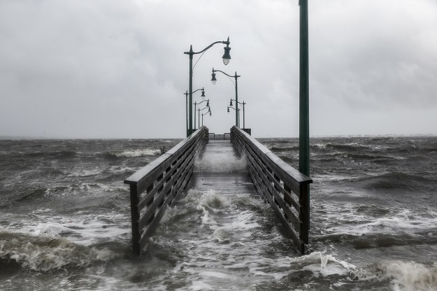 Strong gusts of wind and bands of heavy rain cover a walkway at the Jensen Beach Causeway Park in Jensen Beach, Florida. PHOTO: AFP